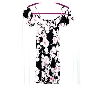 Pink white floral romper on black background